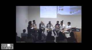 Seven individual speakers sitting at the front of the event space with a projected image behind them