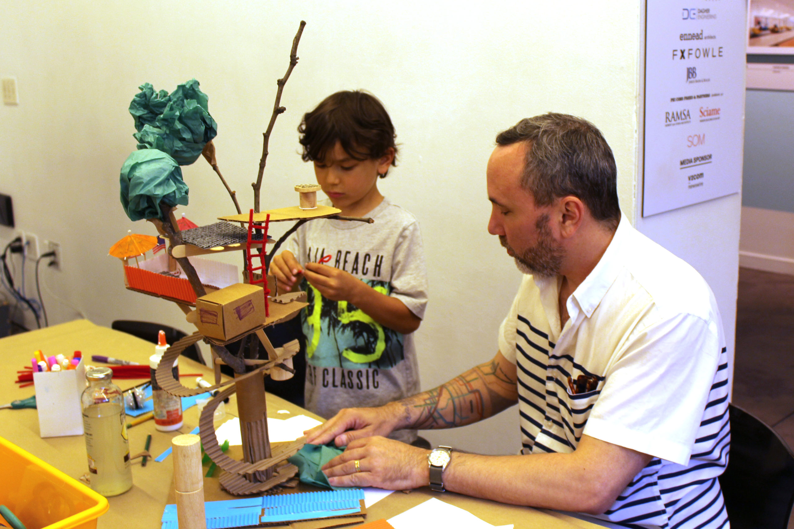 Adult and Child working on model treehouse