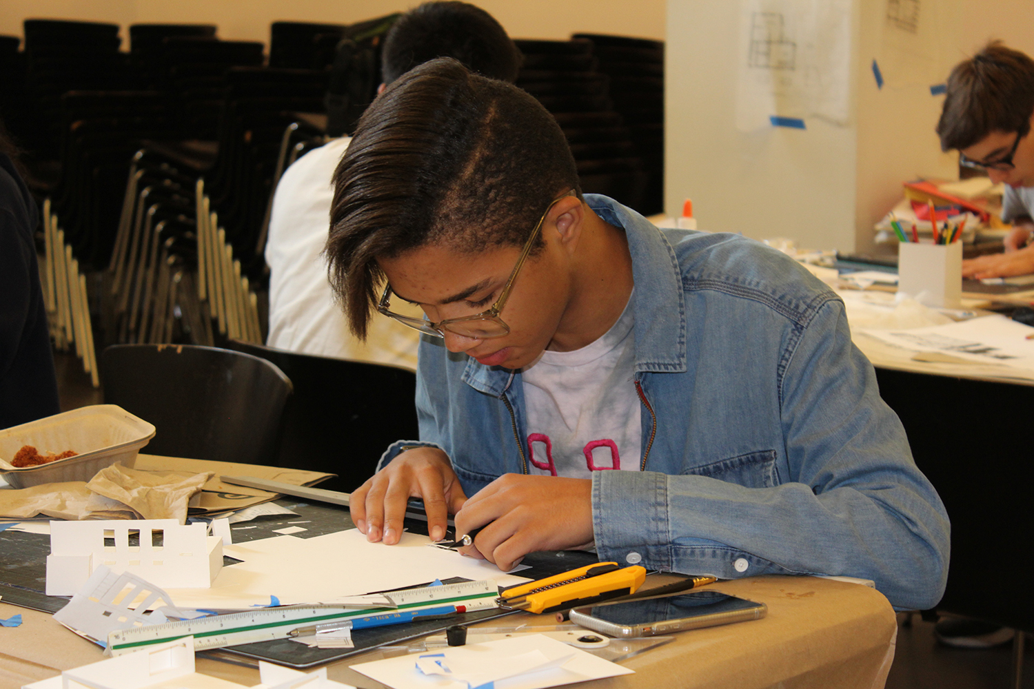 High school student working on architectural model