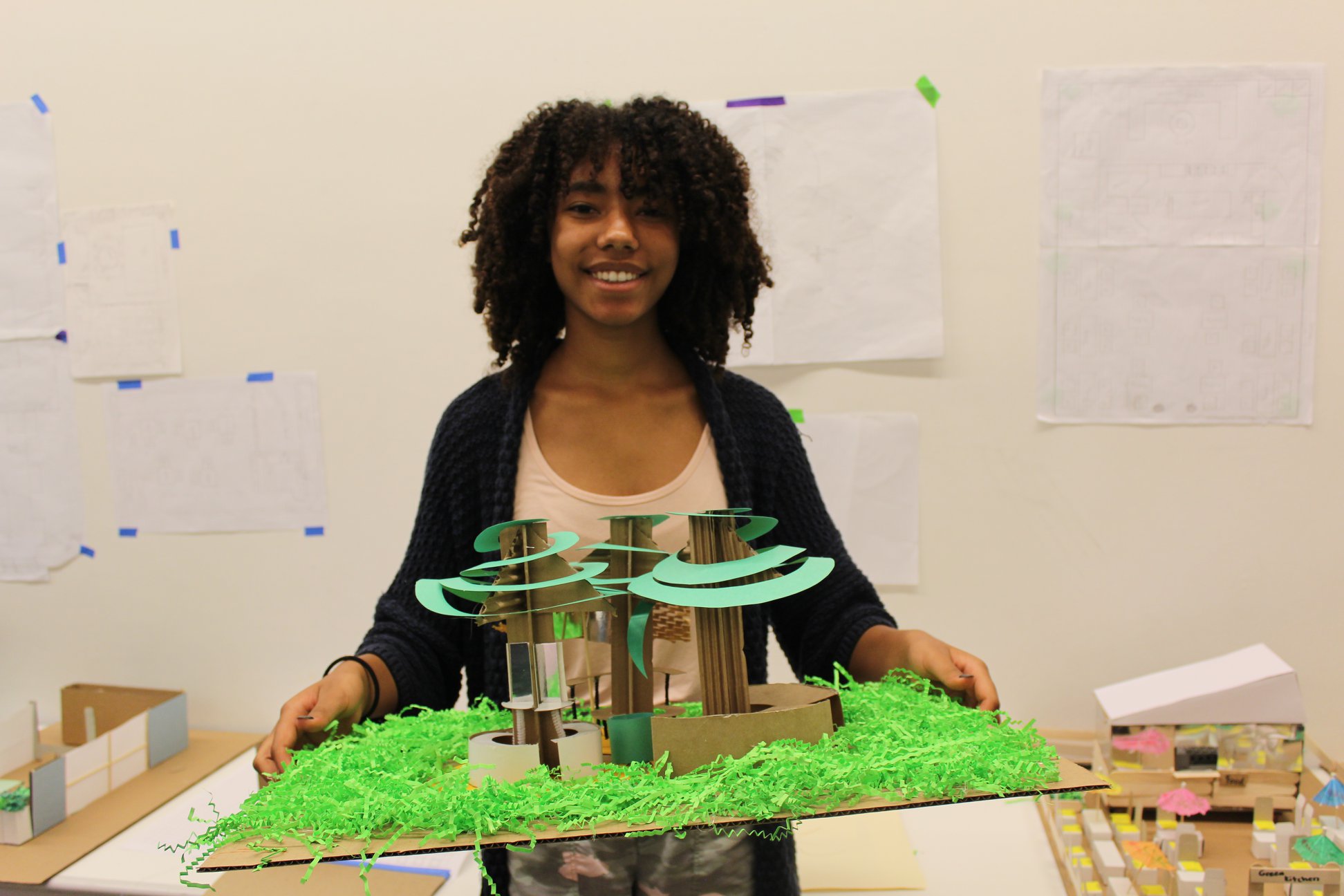 Student holding model of landscape and trees
