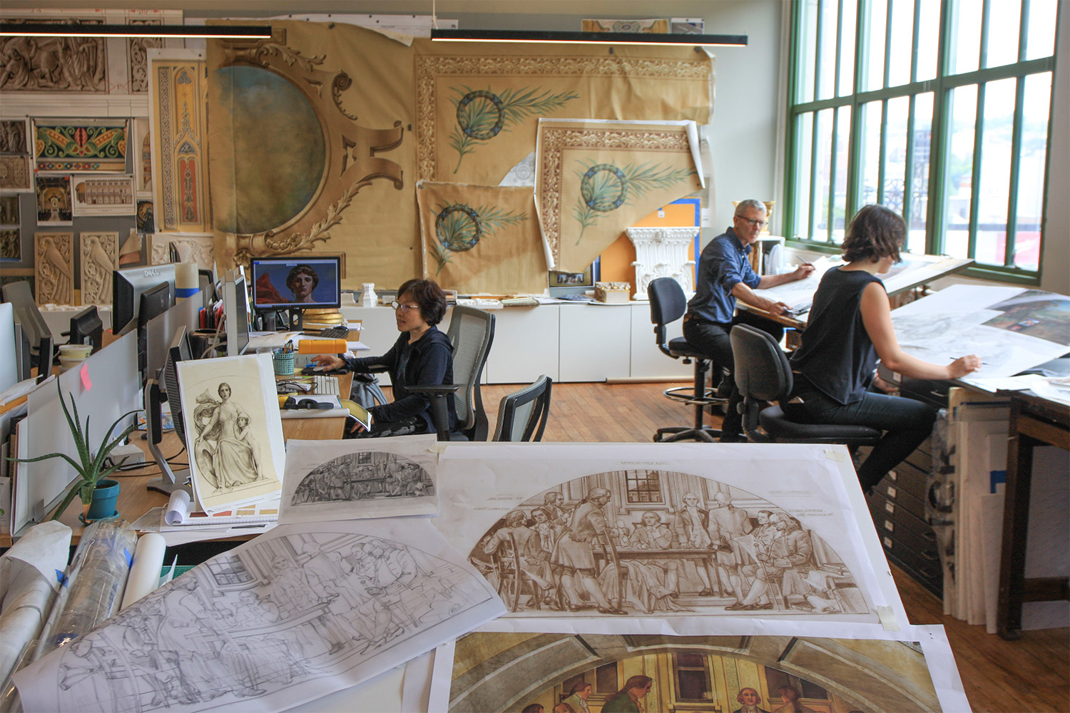 This is an image of studio artists working in the EverGreene Architectural Studio.