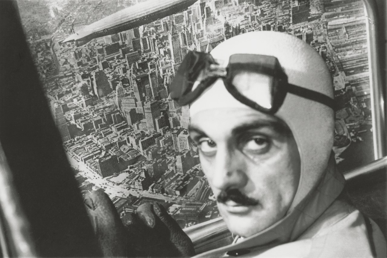 Black and white photo of Carl Mollino wearing goggles and a flight helmet