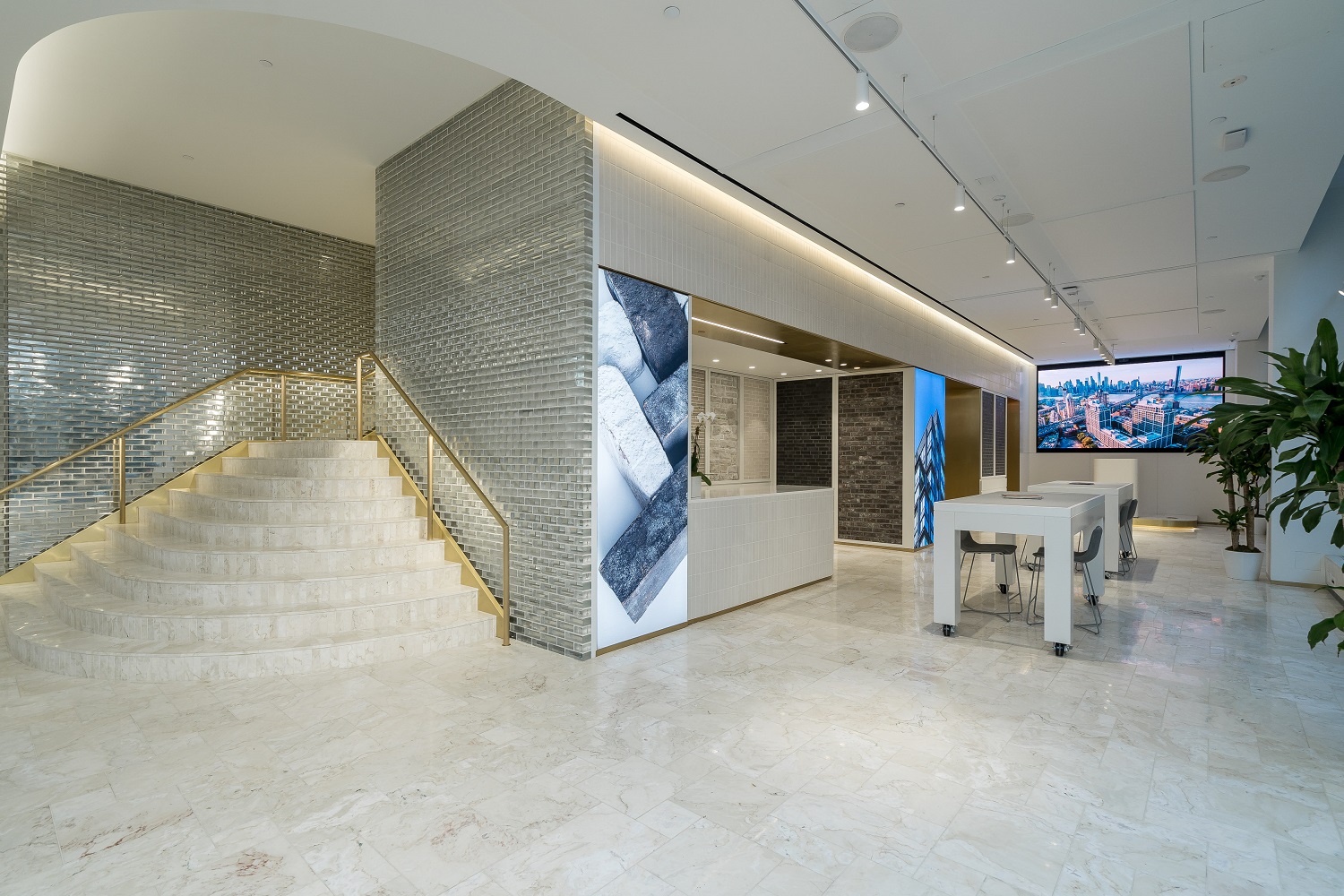 Interior photo of Brickworks Design Studio in New York of white stone walls and floors and stairwell