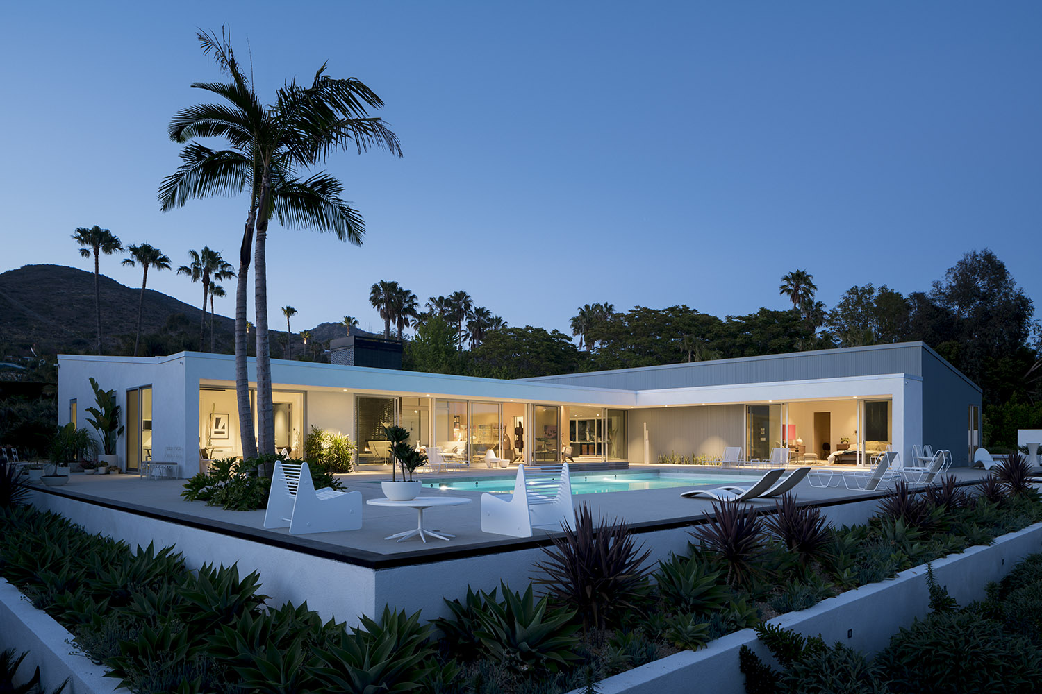 The exterior of Shed House in Malibu showing the modernist structure and its swimming pool at dusk