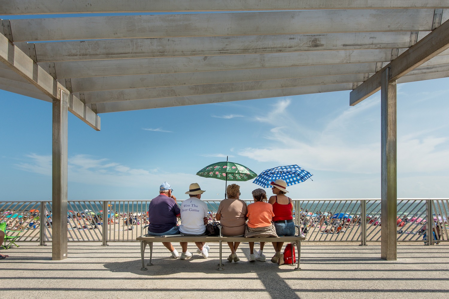 People sitting at a recently completed sitting area at the Rockaway shoreline