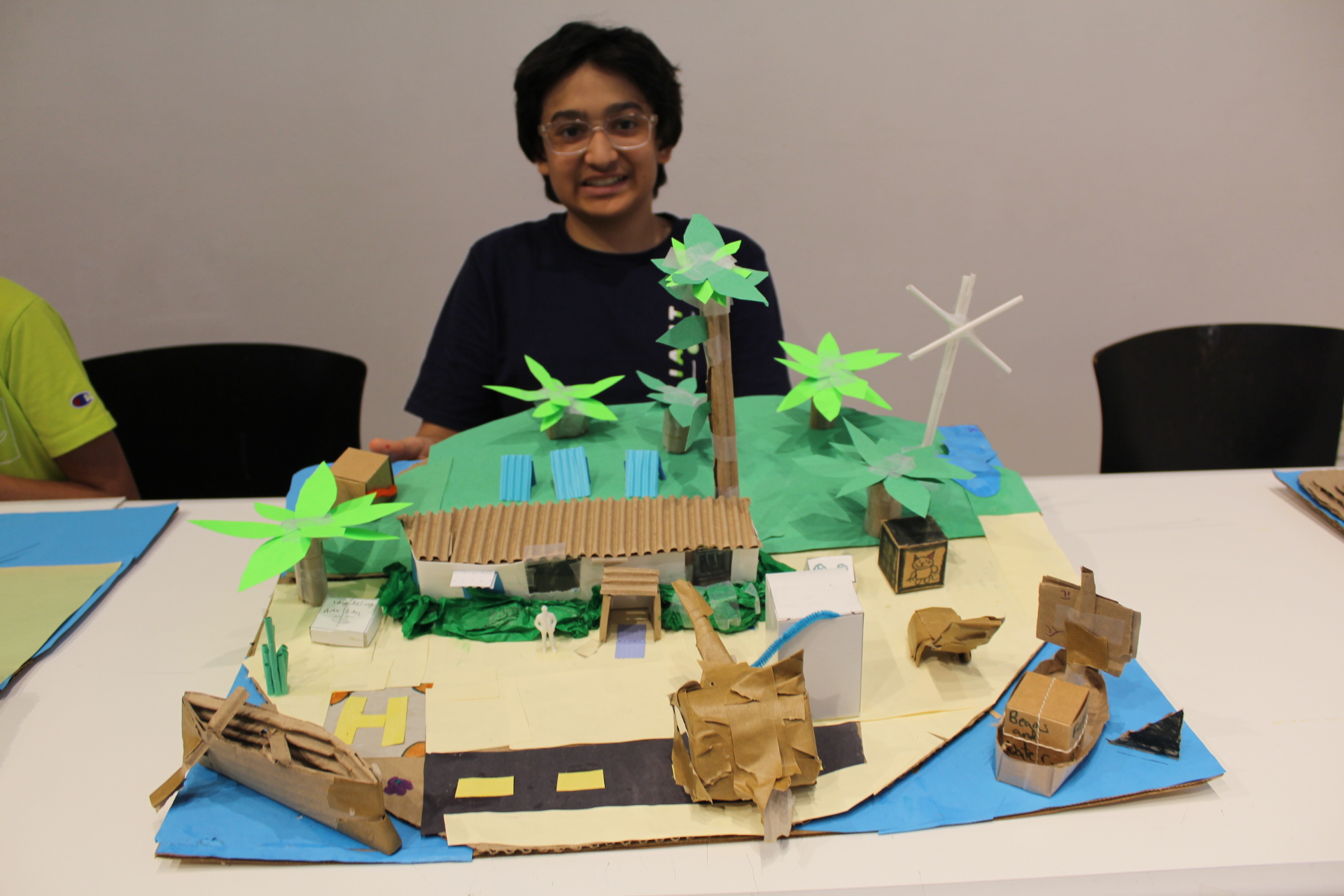 Student with model of island and house