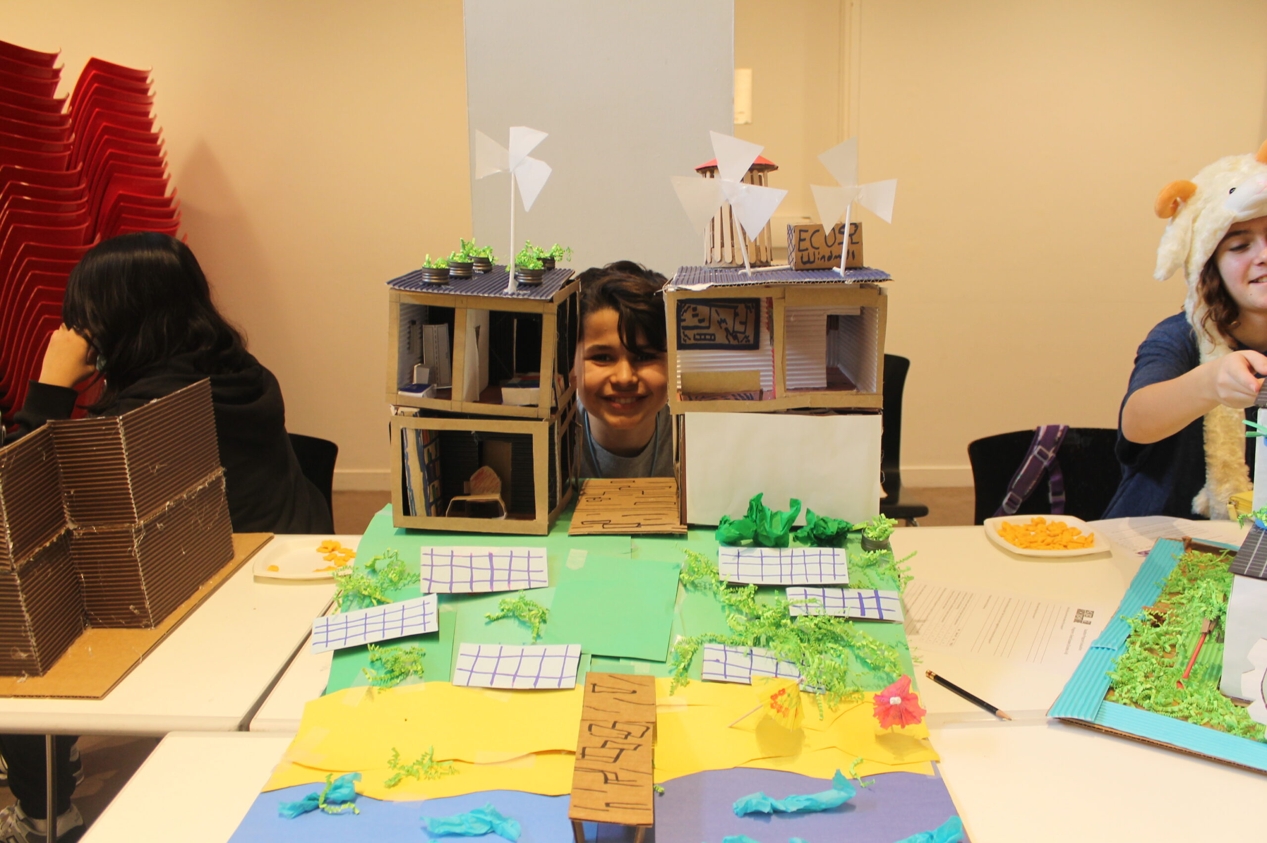 Student with model of beach and house