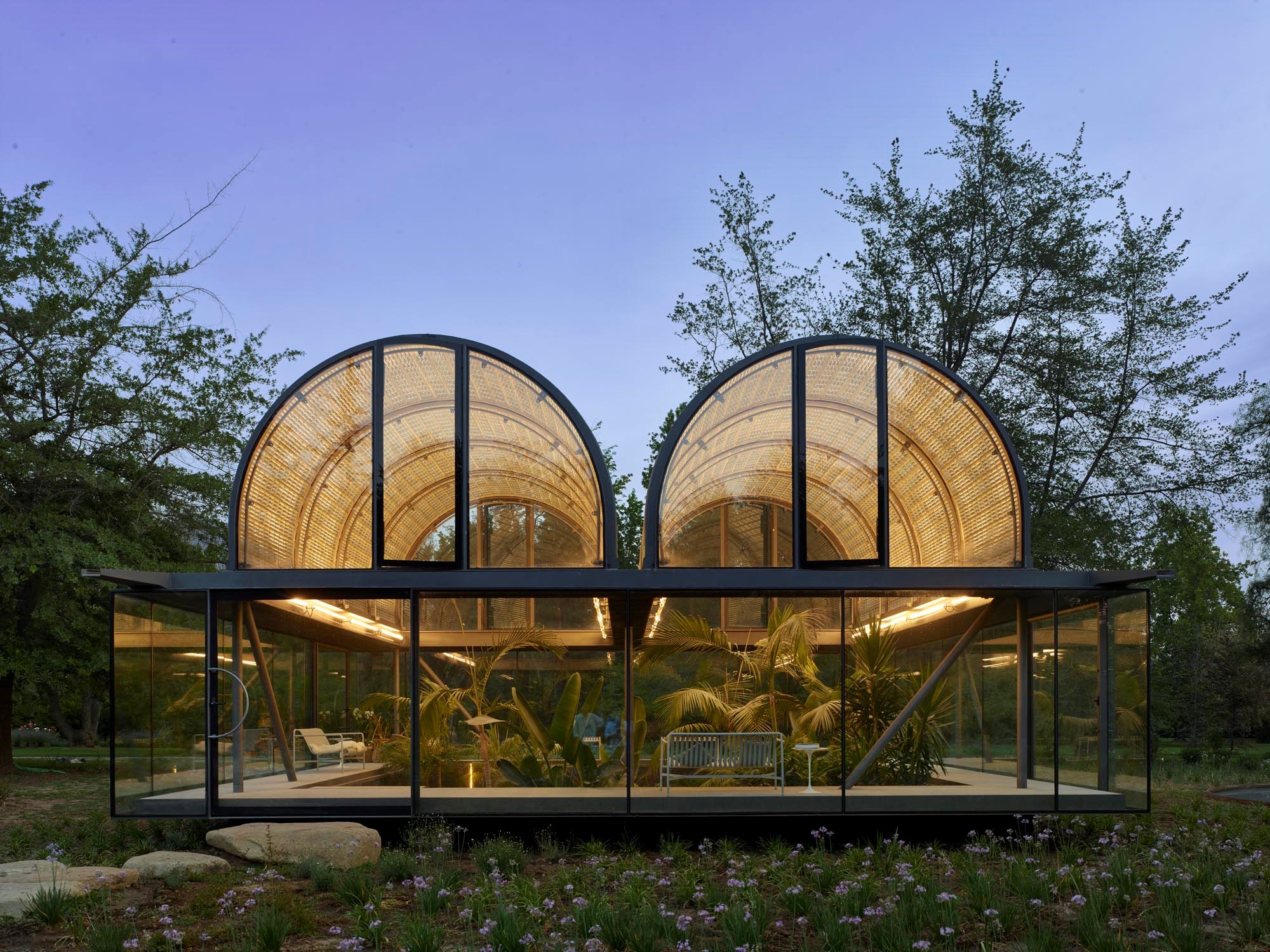 Glass-walled house with dome roof.