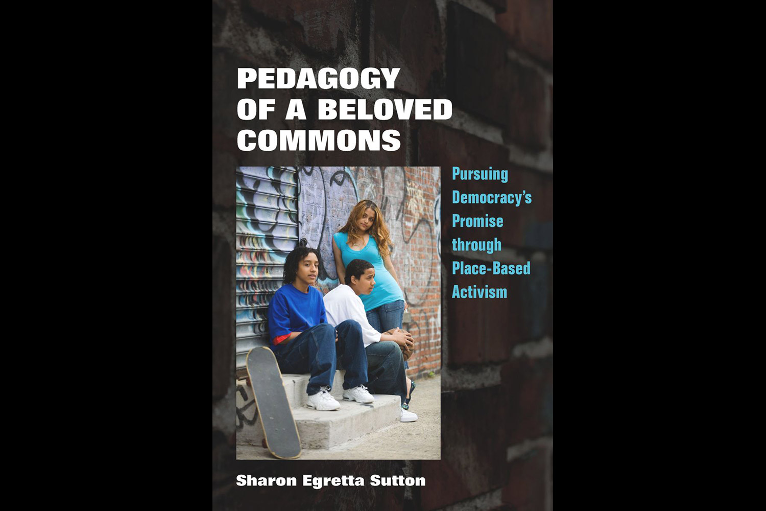 Book cover of "Pedagogy of a Beloved Commons" with an image of three people leaning against a wall on the street.