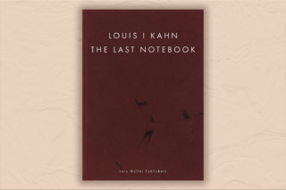 Maroon book with minimal text against a beige background.