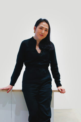 Portrait of Melinda Koo leaning against a counter