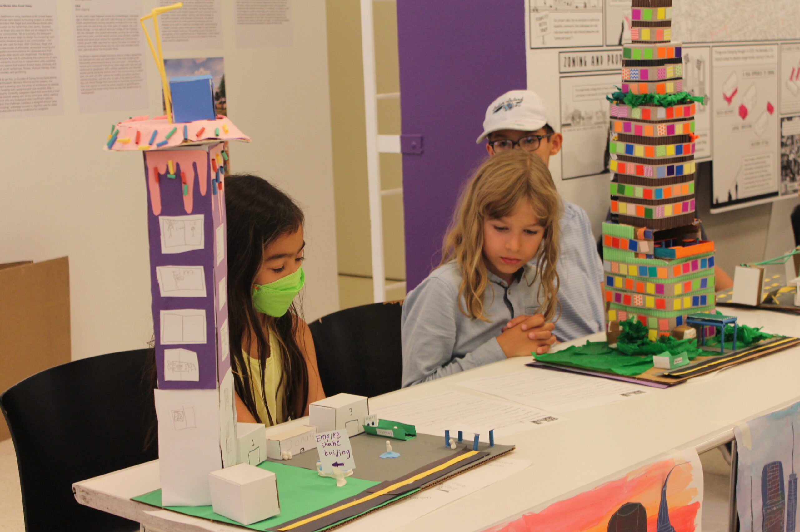 Two elementary school students with their model skyscrapers.