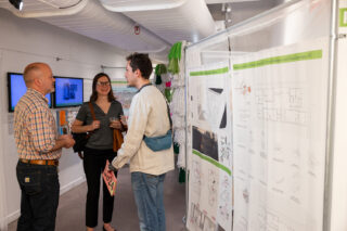 Members of the public speaking amongst the Spatializing Reproductive Justice exhibition