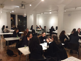 People seated and speaking to each other across a table at aWIA Speed Mentoring Event