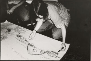 Participant in fantasy environment exercise in Phyllis Birkby and Leslie Kanes Weisman’s course “Women and the Built Environment: Personal, Social, and Professional Perceptions,” at the first session of the Women's School of Planning and Architecture, Biddeford, Maine, August 1975.