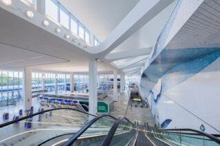 Interior shot from descending escalators of the terminal at LaGuardia Airport.
