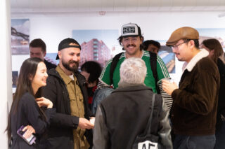 People standing and talking in a group during a happy hour event at the Center for Architecture