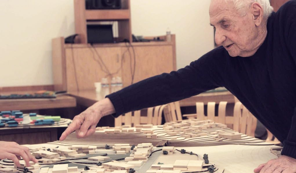 Image of Frank Gehry pointing at a model