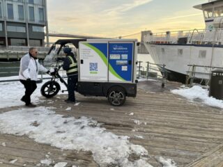 Image of two people near a delivery cart