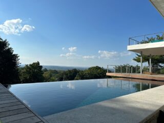 Exterior image featuring an infinity pool