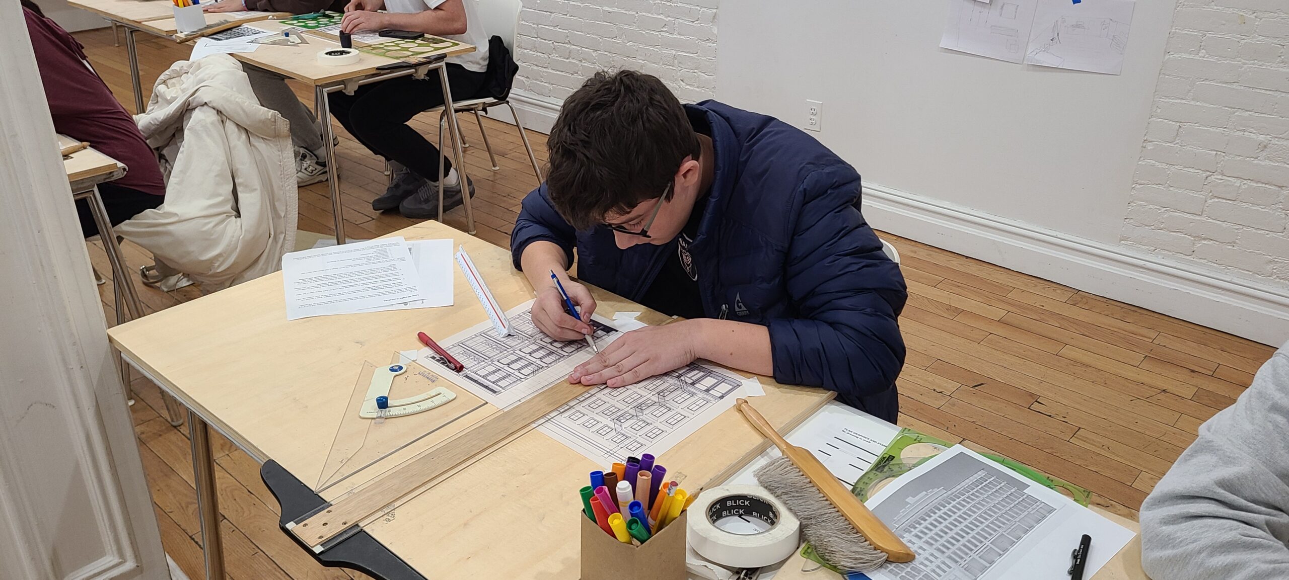 Teen drawing a building